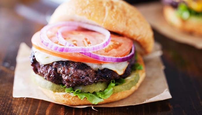 Cheeseburger topped with onion, lettuce, pickle, tomato served at Clear Water Harbor restaurant and bar in Waupaca, WI