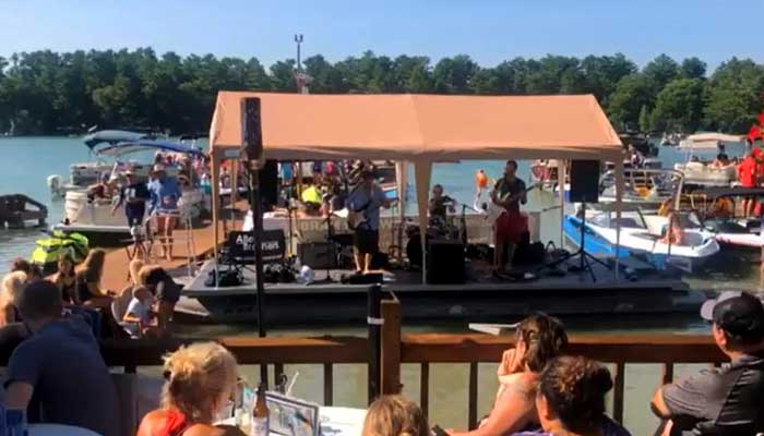 Live music on the pontoon boat stage on the Chain O' Lakes at Clear Water Harbor restaurant and bar in Waupaca, WI