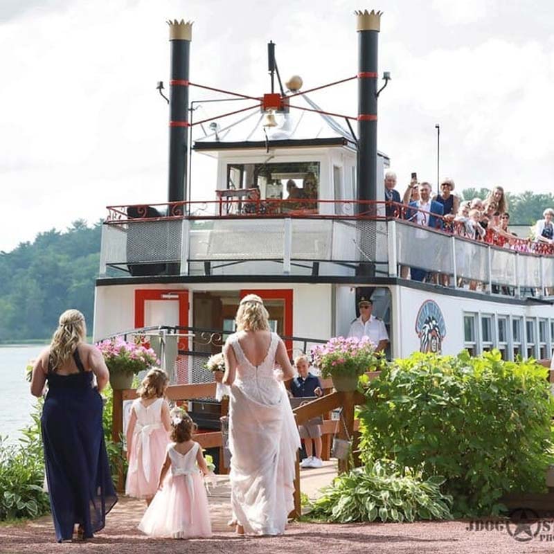 Bride and bridesmaids board the Chief Waupaca cruise tour boat on the Chain O' Lakes at Clear Water Harbor restaurant and bar in Waupaca, WI