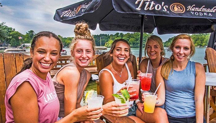 Guests cheers specialty cocktails, iced teas and lemonades, along the Chain O' Lakes waterfront at Clear Water Harbor restaurant and bar in Waupaca, WI